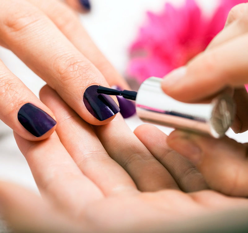Woman having nails painted - The Beauty Shack Salon Logo