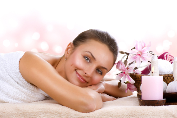 Women with aromatherapy candles and flowers